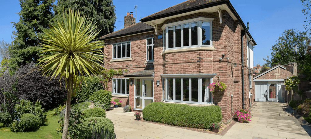 Aluminium windows vs uPVC: Which is right for your property? 2 sheerline aluminium bay windows on the exterior of a red brick home