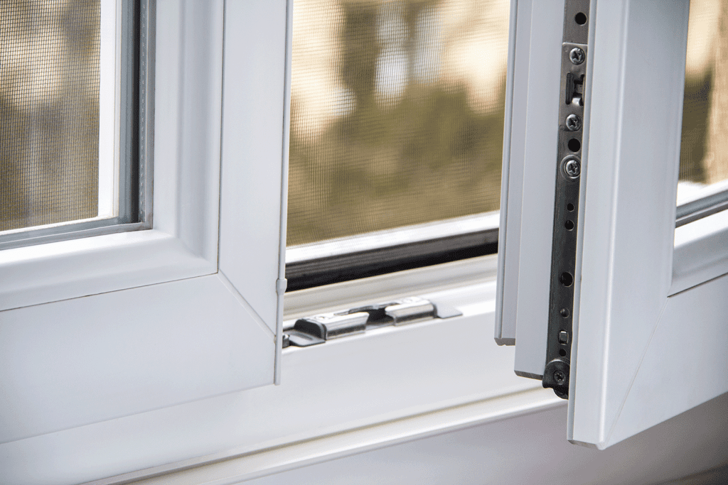 close up photo of a white upvc french window open ajar