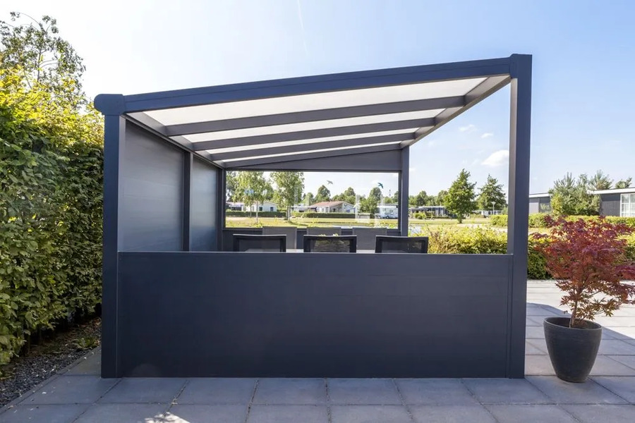 Freestanding grey veranda structure with a white-striped roof and dark solid side panels, creating a semi-private outdoor dining area.